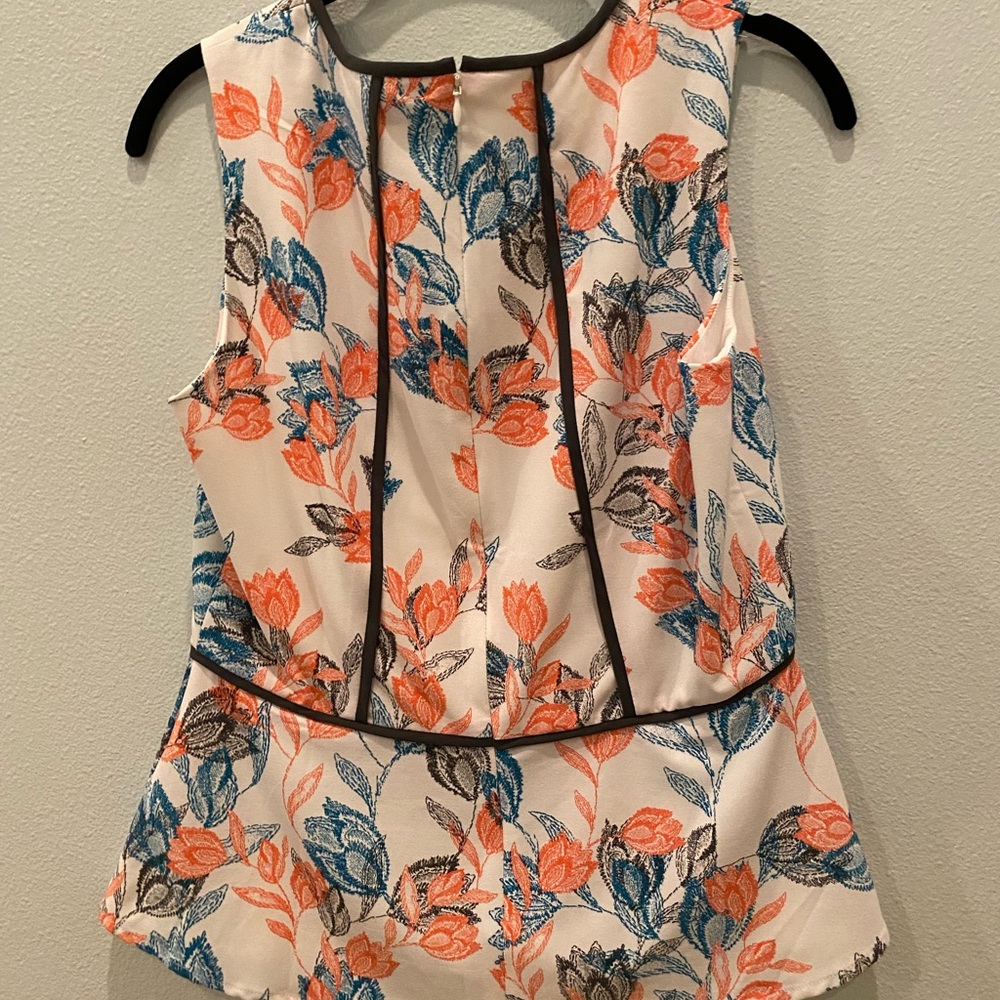 Banana Republic. White peplum top with pink, green and black print. Size 4
